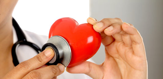 Female doctor holding a beautiful red heart shape