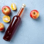 top view apple vinegar in bottle on white background juice fruit color photo fresh drink sour food