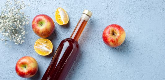 top view apple vinegar in bottle on white background juice fruit color photo fresh drink sour food
